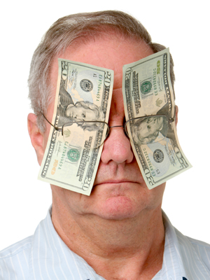 man blinded by dollar bills