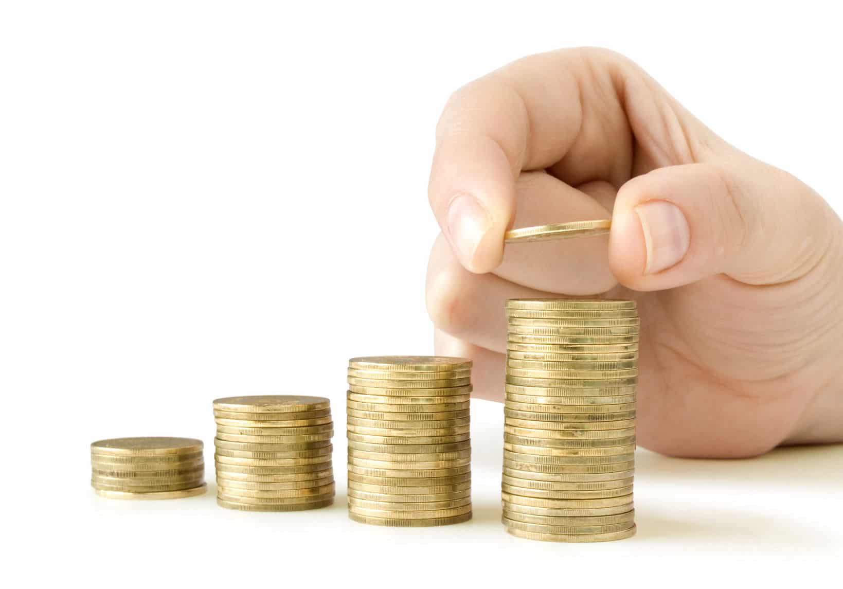 29784057 – coins in finger and row stacks them isolated on white Managing Your Money